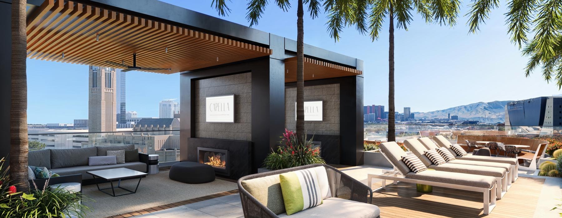 a patio with a fireplace and chairs