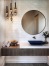 a bathroom with a round mirror